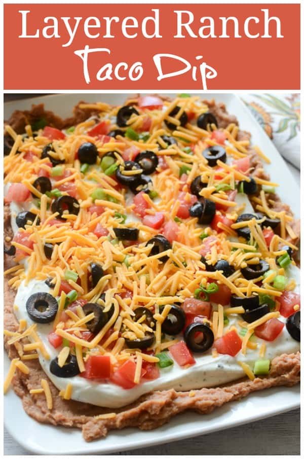 Layered Ranch Taco Dip - layers of refried beans, sour cream with ranch, tomato, olives, cheese, and more! No cooking involved!